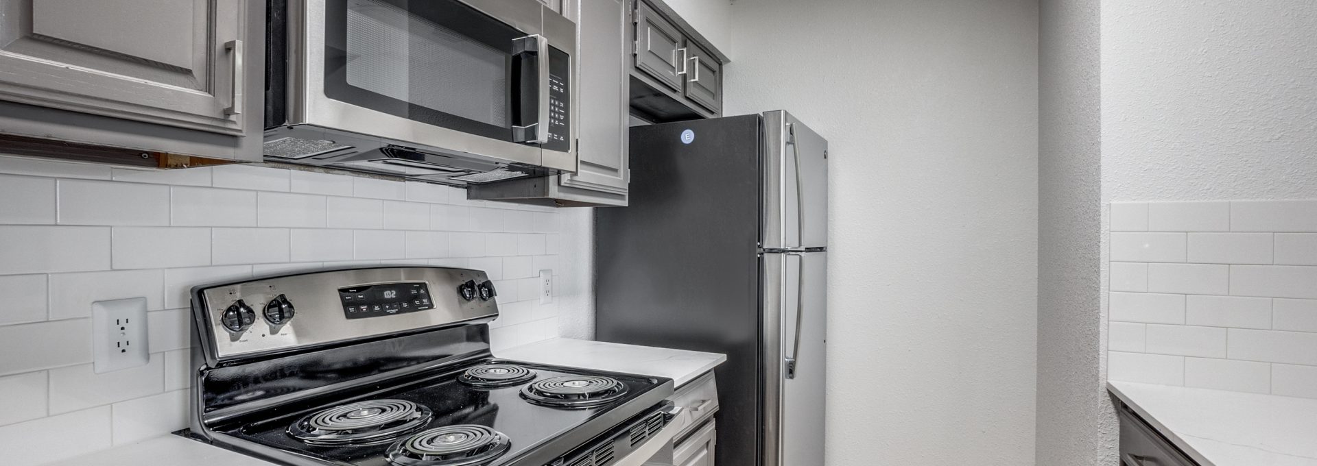 kitchen with stainless steel appliances and white cabinets at The  Laney