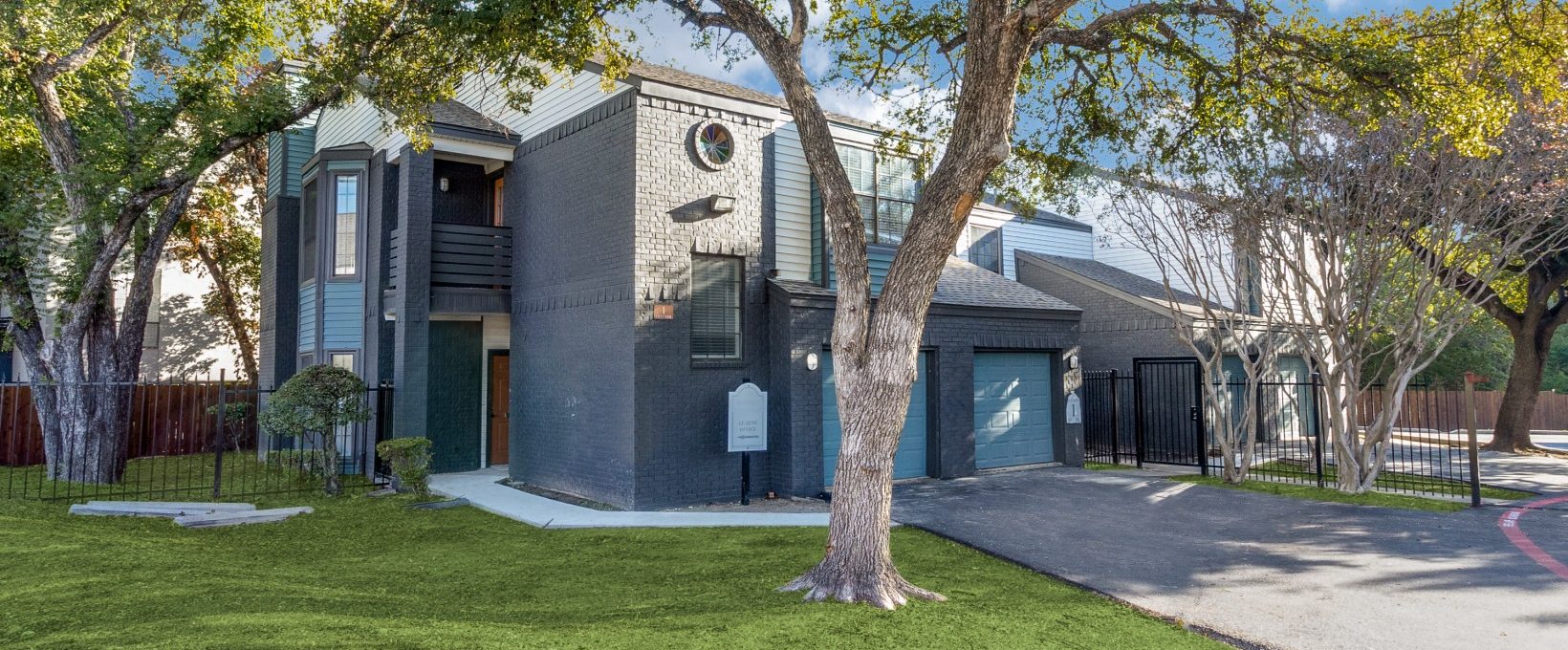 a home with a driveway and trees in the front yard at The  Laney