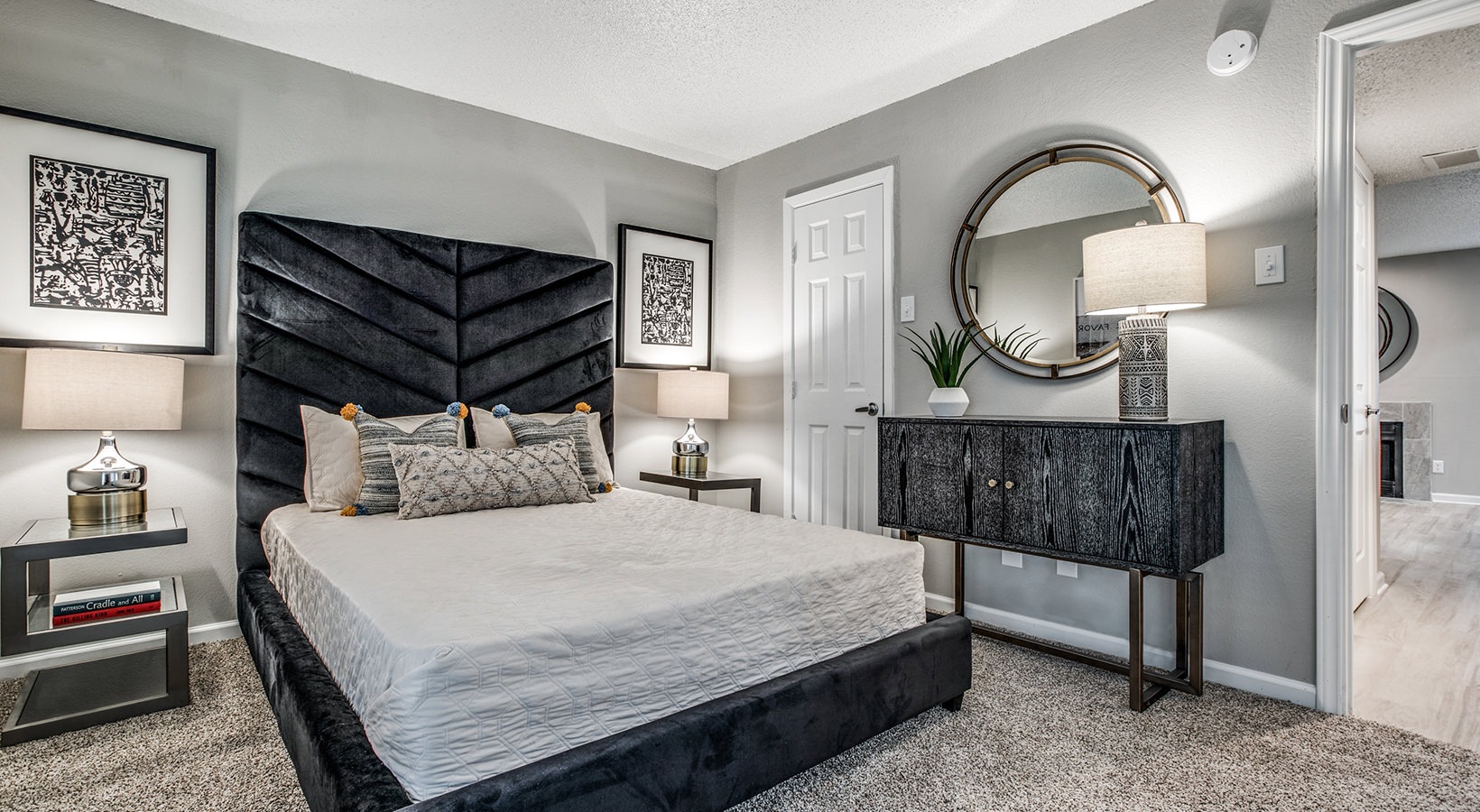 a bedroom with a black bed and a mirror at The  Laney