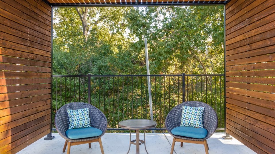 a patio with two chairs and a table at The  Laney
