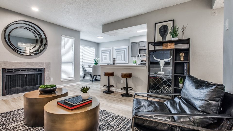 the living room has a fireplace and a large mirror at The Laney